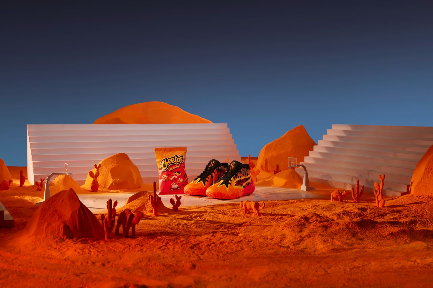 Scoot Henderso's orange and black PUMA shoes next to a Cheetos bag.